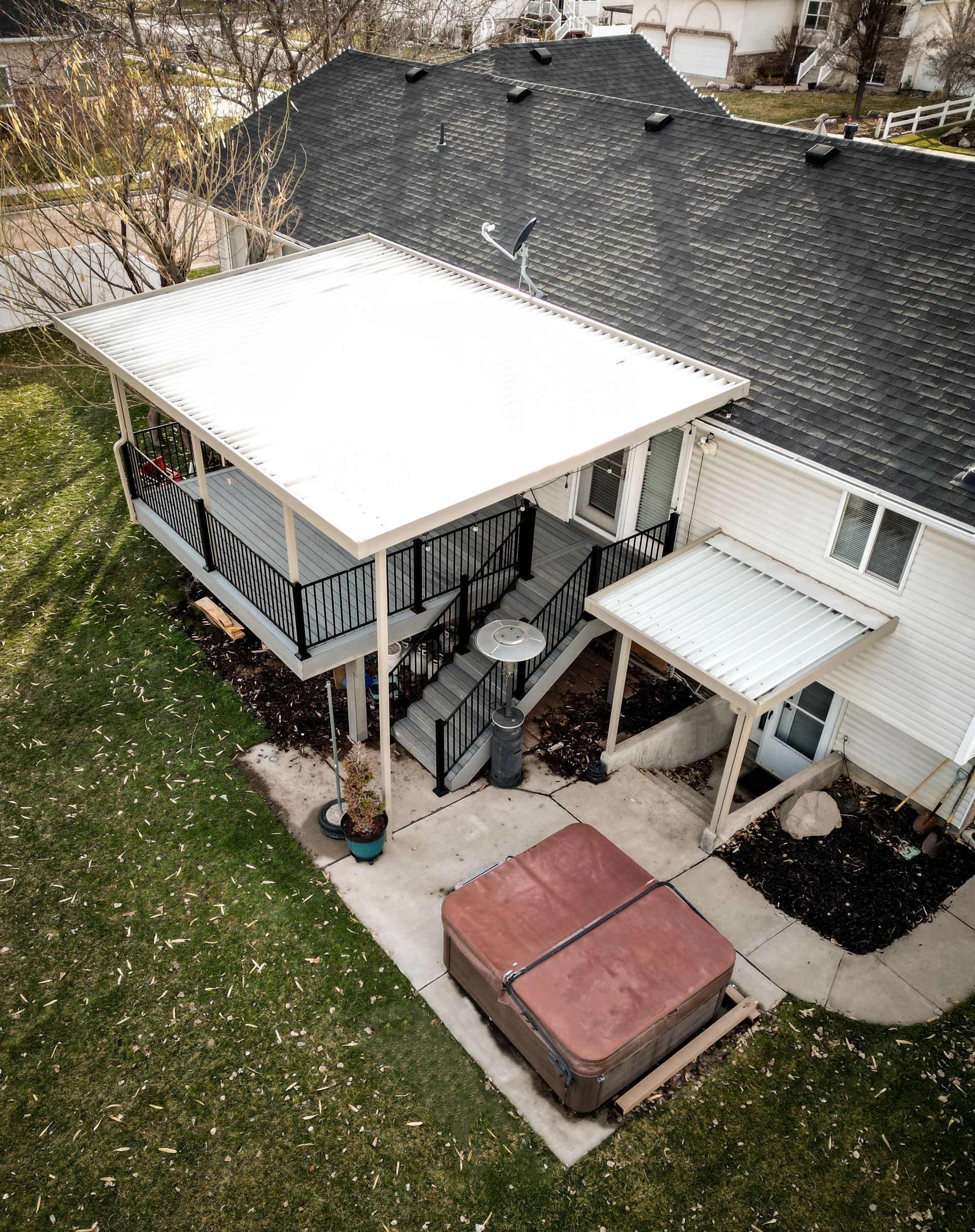 An aerial view of a house with a hot tub on the patio.