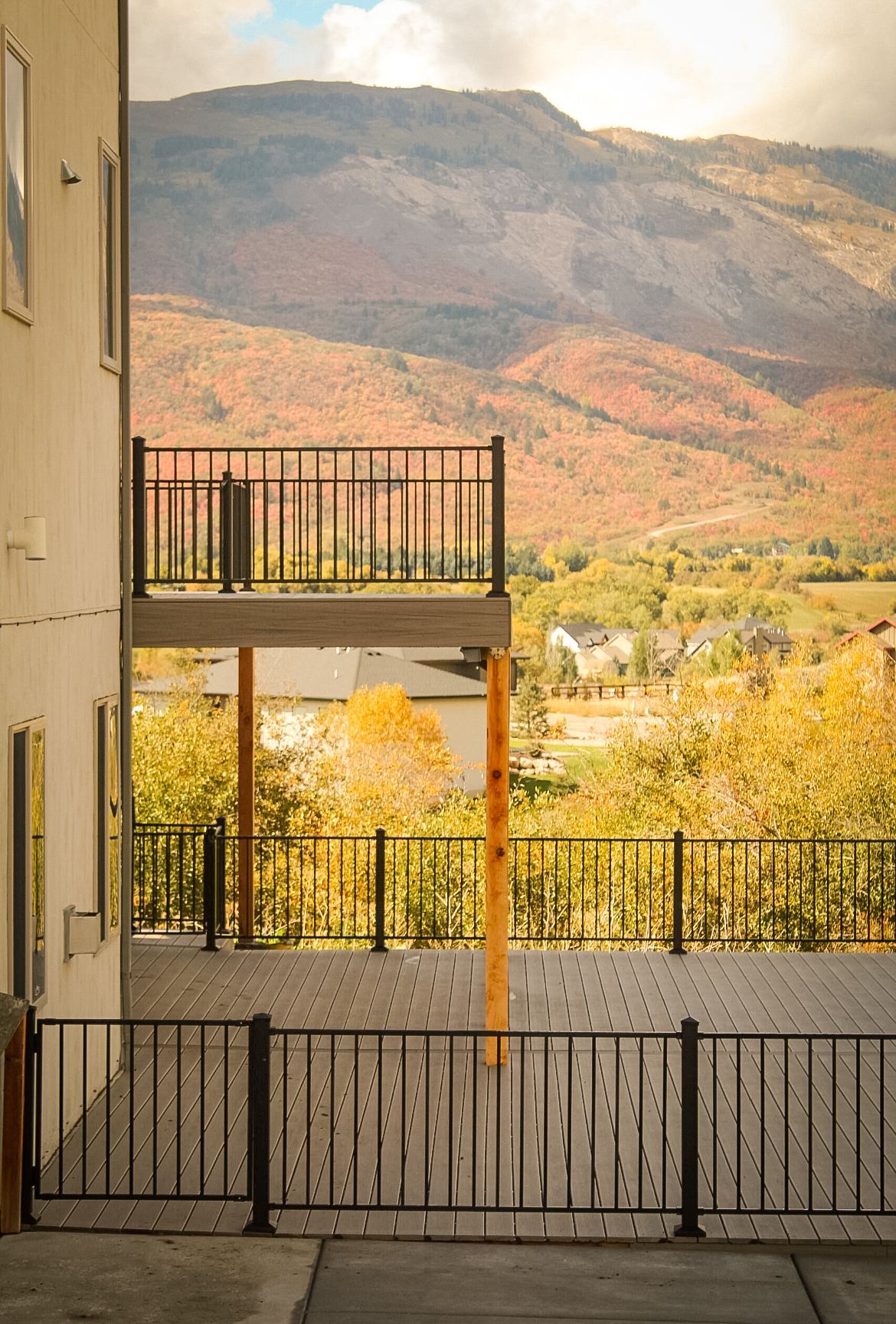 There is a balcony with a view of the mountains in the background.