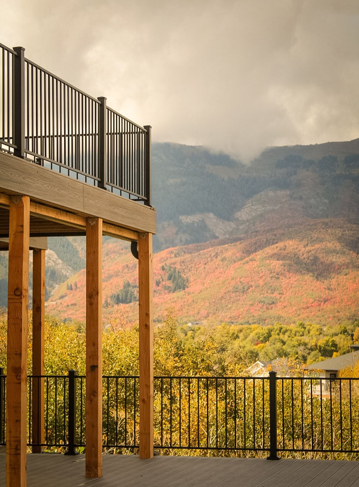 A deck with a view of mountains and trees