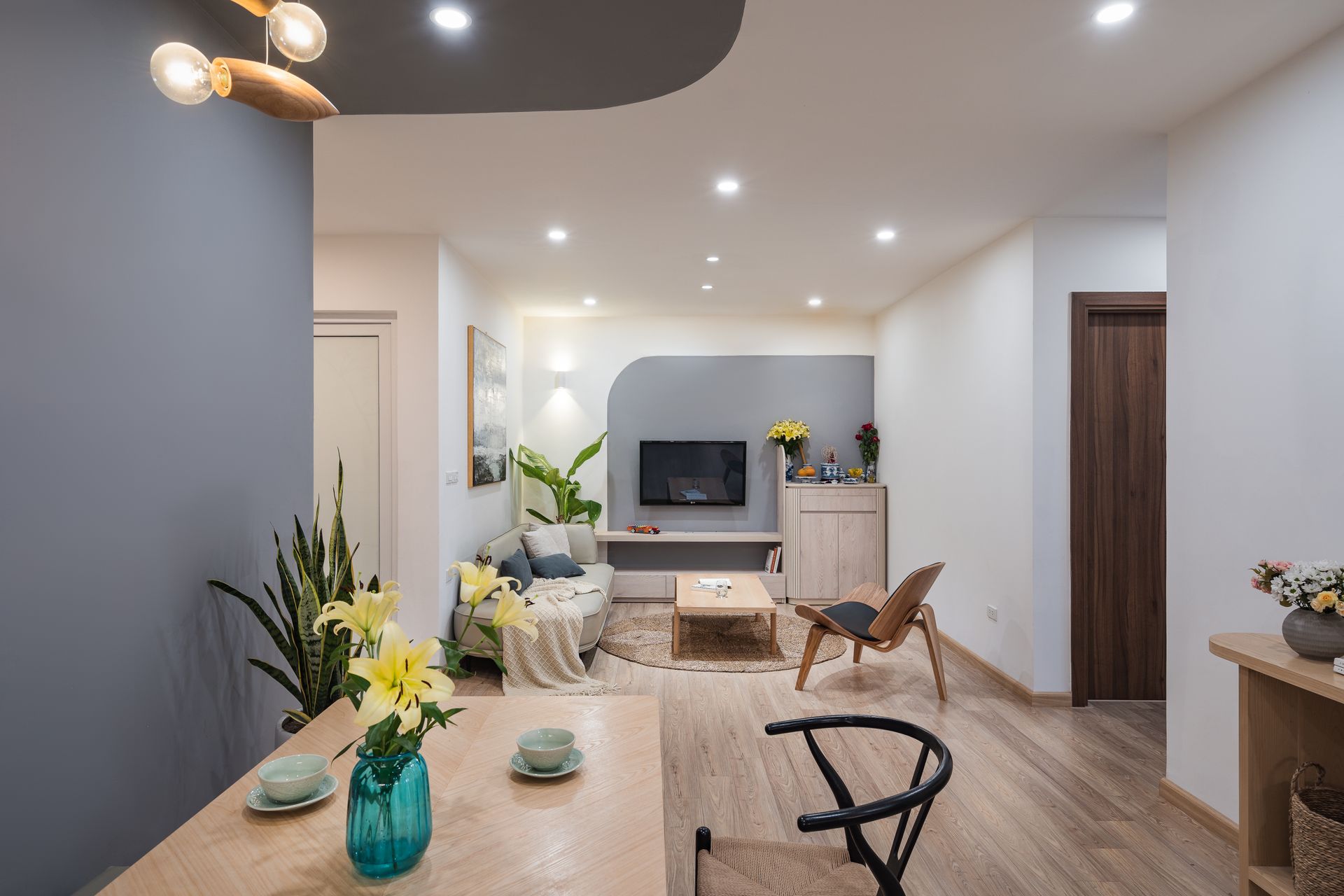 Room under construction with exposed drywall and building materials. Two windows, scaffolding, and wood floor visible.