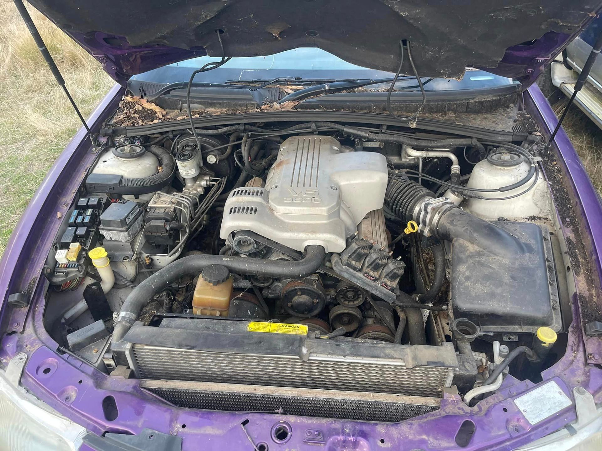 The Engine Of A Purple Car Is Shown With The Hood Open — R N R Wrecking N Scrap Car Removal In Beard, ACT