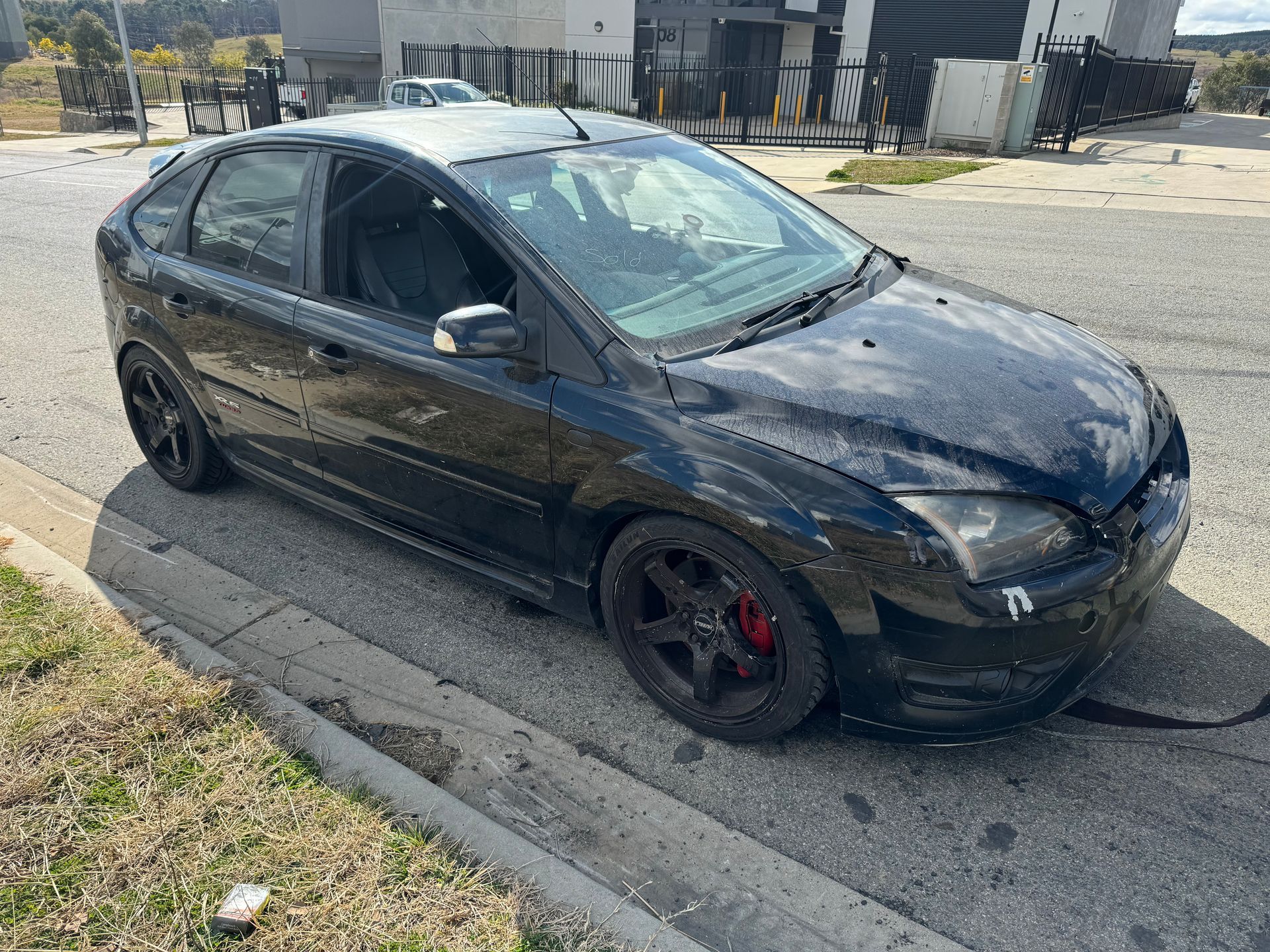 A Black Car is Parked on the Side of the Road — R N R Wrecking N Scrap Car Removal In Beard, ACT