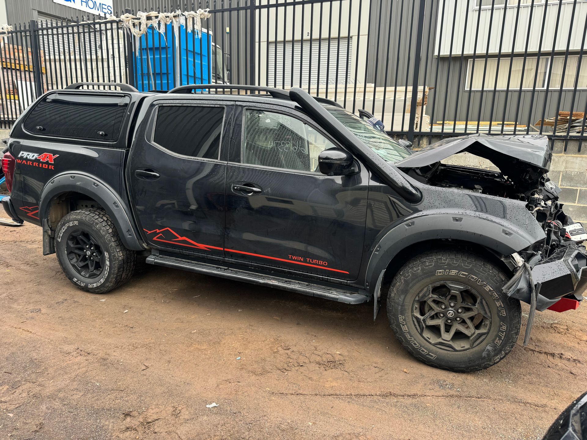 A Black Truck With a Broken Hood is Parked in Front of a Fence — R N R Wrecking N Scrap Car Removal In Beard, ACT