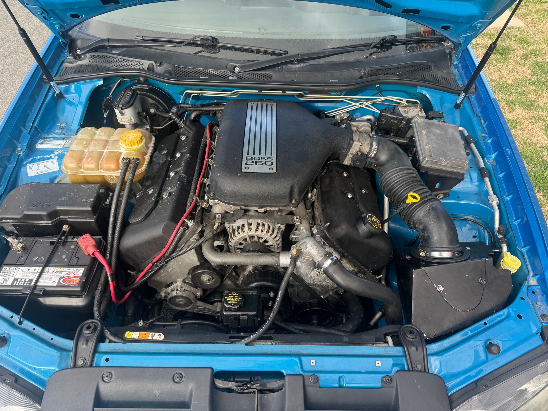 The Engine of a Blue Car is Visible Under the Hood — R N R Wrecking N Scrap Car Removal In Beard, ACT
