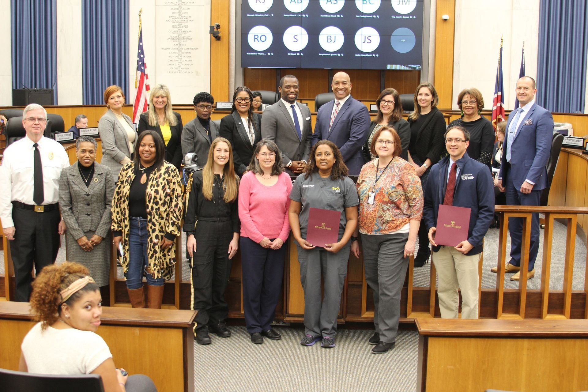 A group of people are posing for a picture in a courtroom.