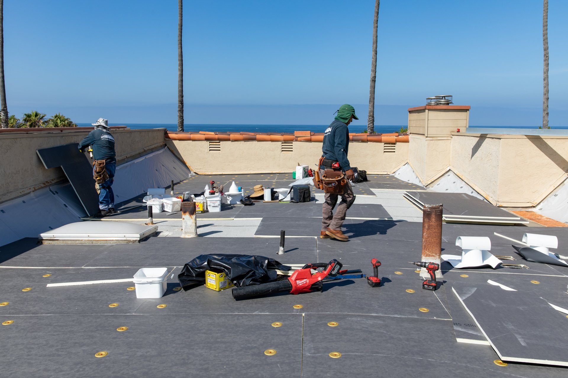 Couple of workers on large roof Fallbrook