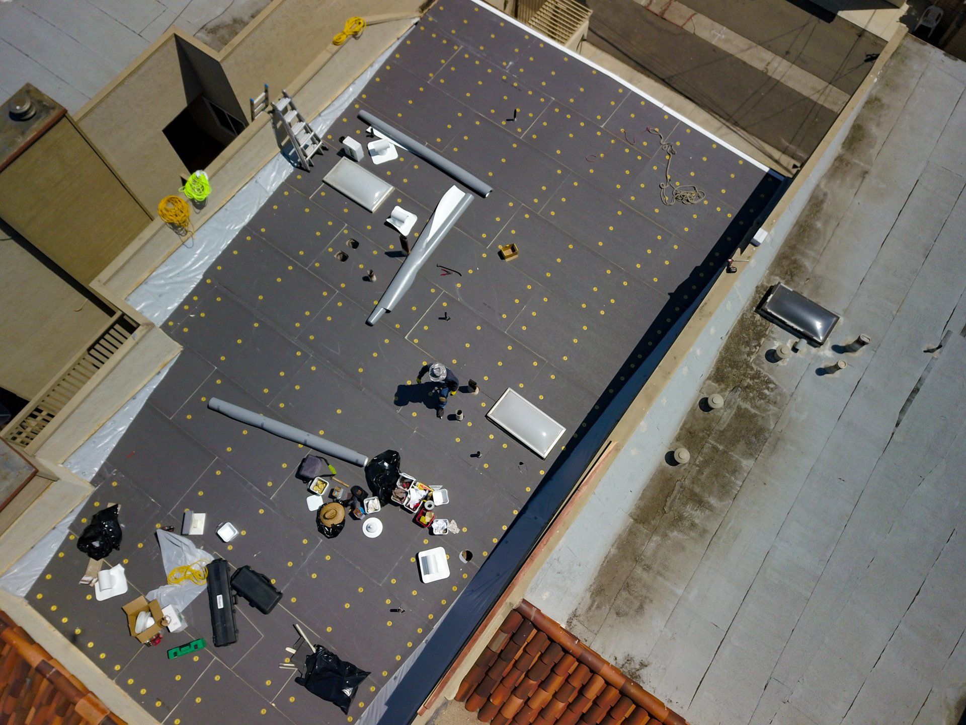 Large commercial roof with roofing team