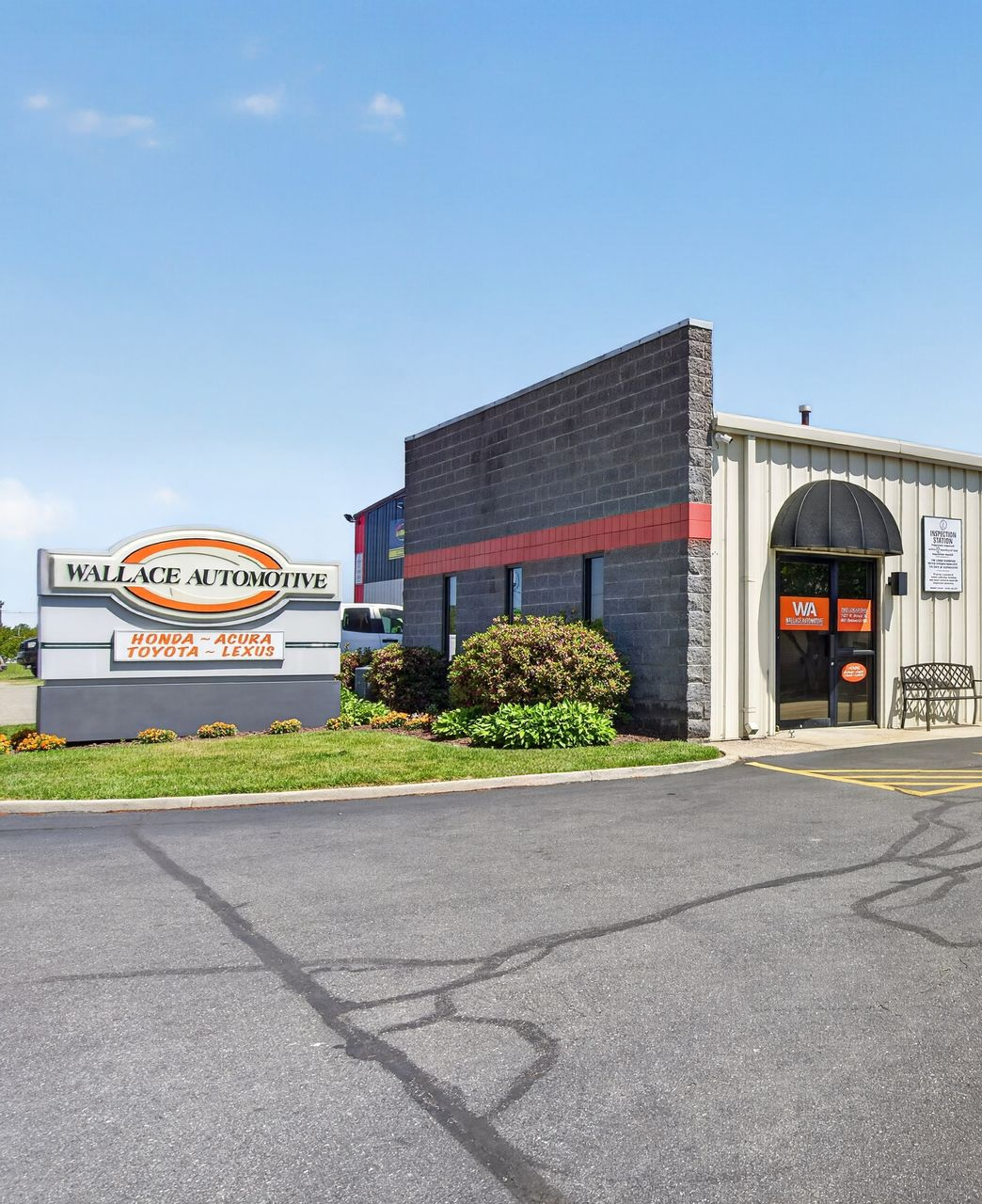 Outside of our shop with our Logo on a sign | Wallace Automotive Inc