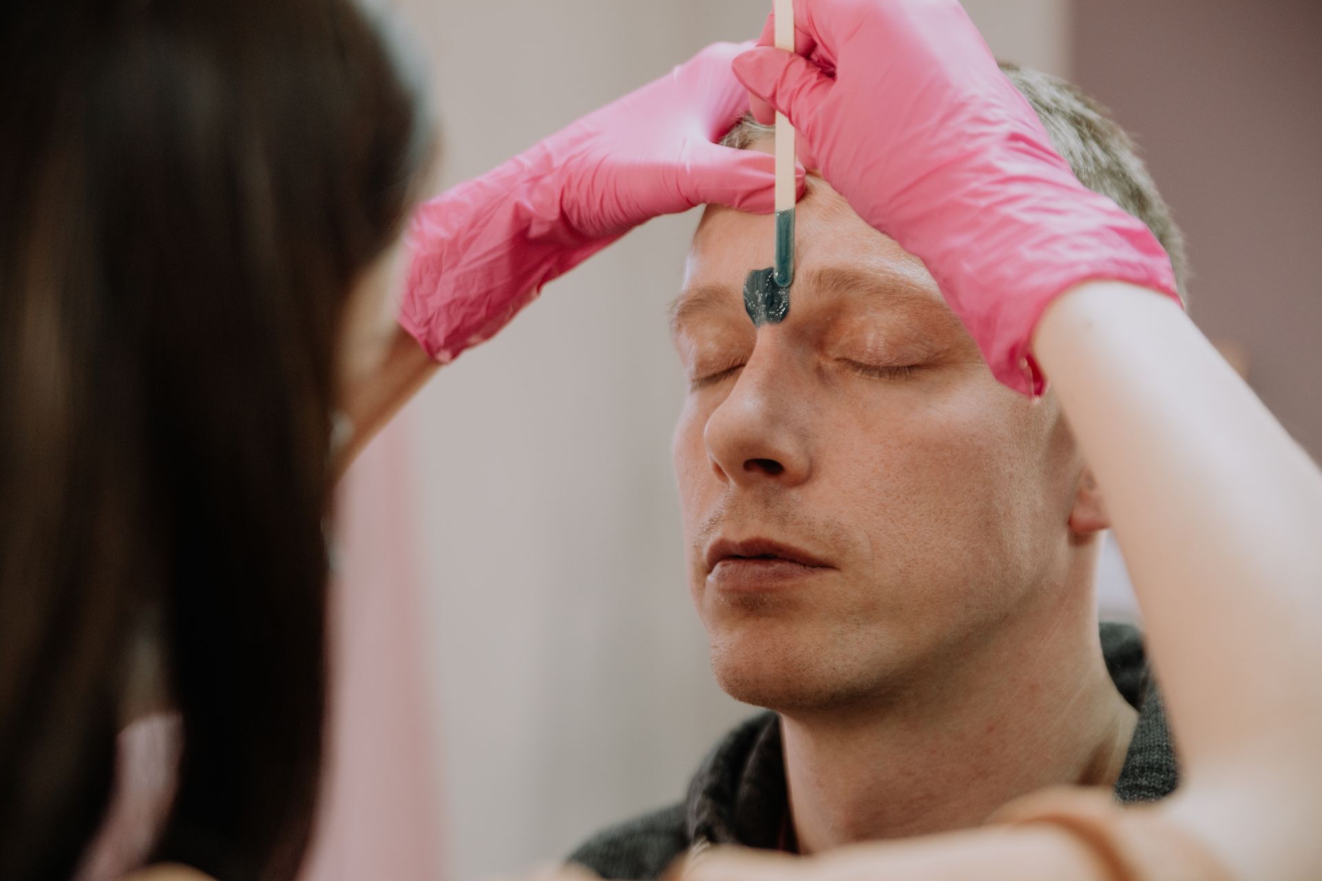 man getting his eyebrows waxed