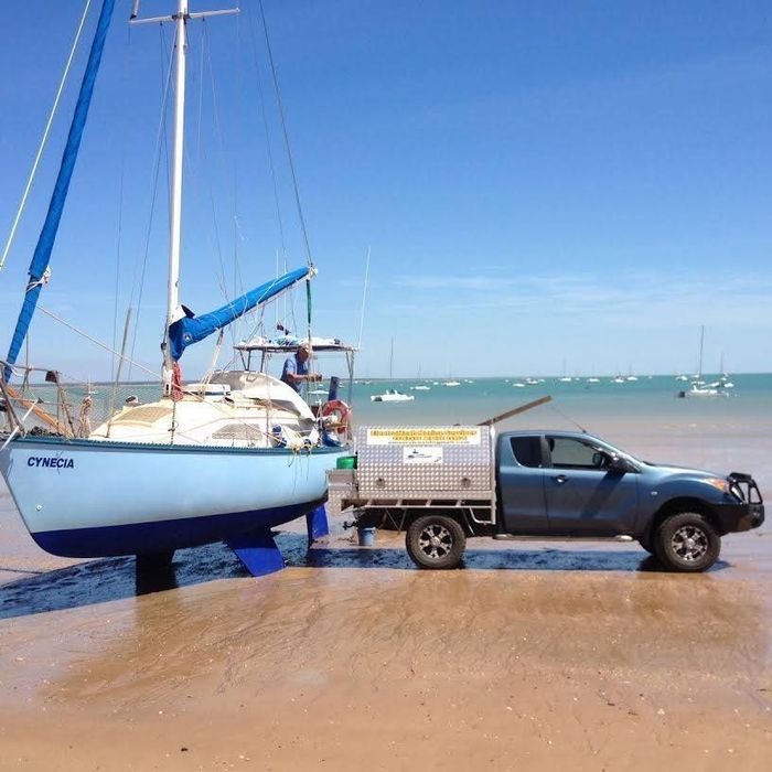 A Boat Is Being Towed by A Truck on The Beach — ElectroMech Marine in Darwin, NT