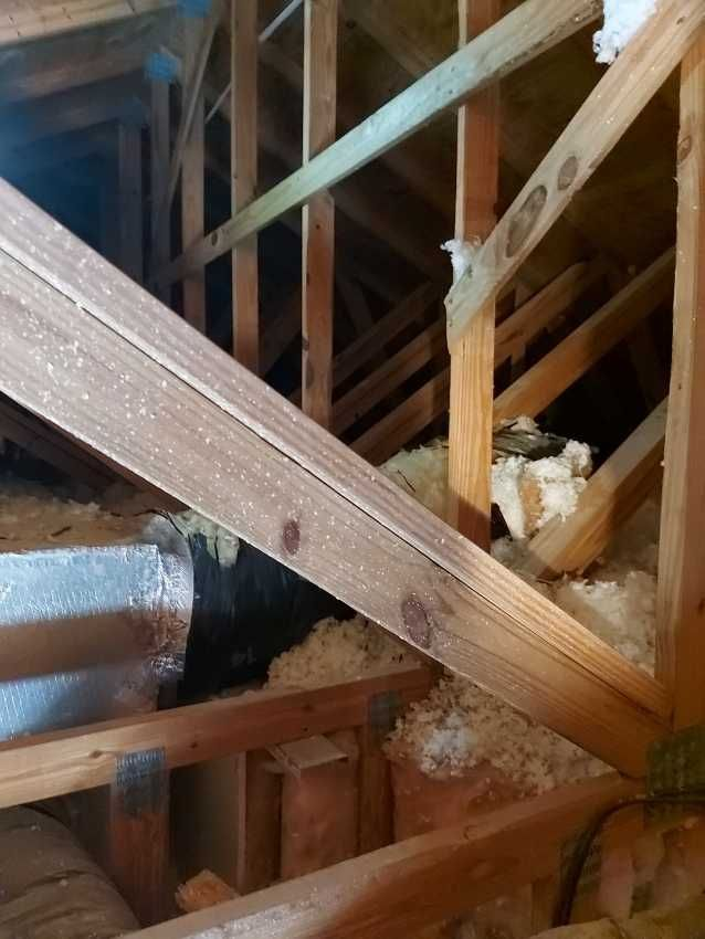 A wooden structure with a pipe in the middle of it