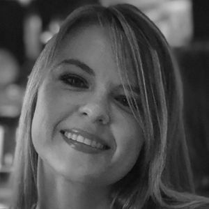 Woman with fair skin smiles.