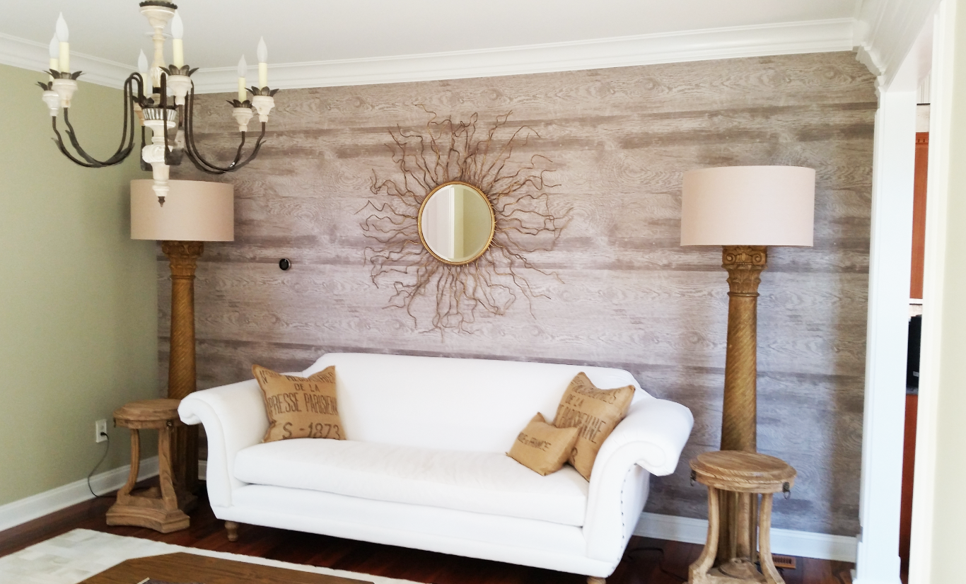 A living room with a white couch and two lamps