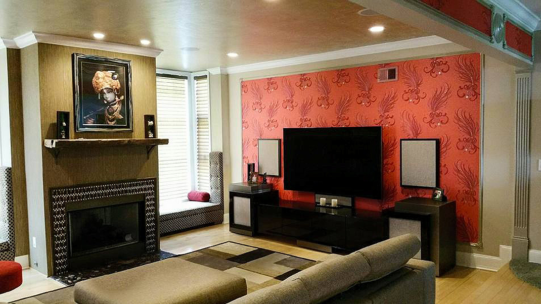 A living room with a couch , fireplace and television.