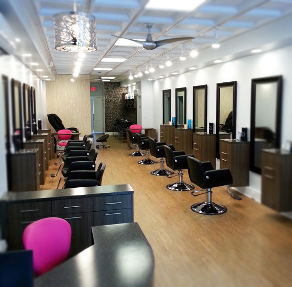 A hair salon with lots of chairs and mirrors