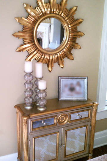 A dresser with candles and a mirror above it
