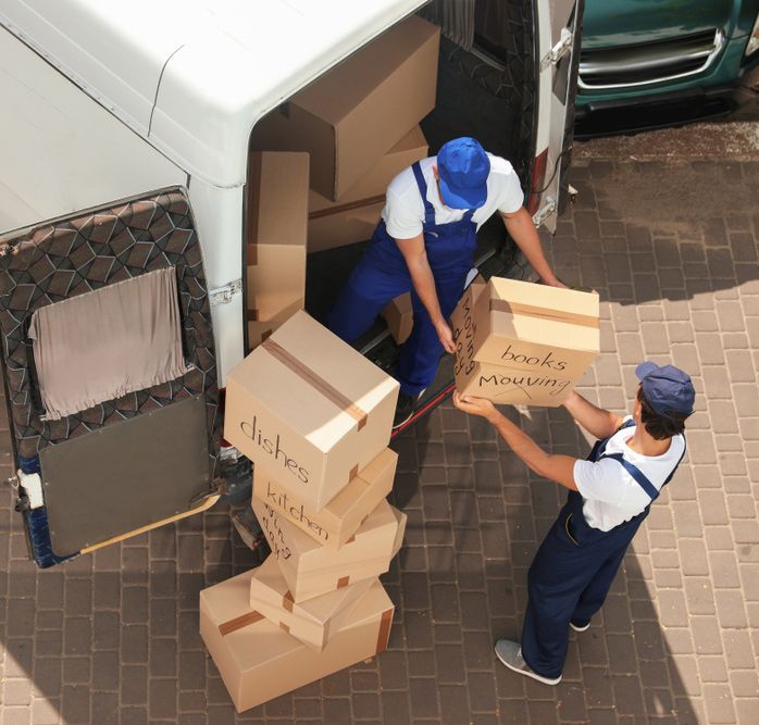 Two Men Are Loading Boxes Into a Van and One of the Boxes — Johns Removals Newcastle In Newcastle, NSW