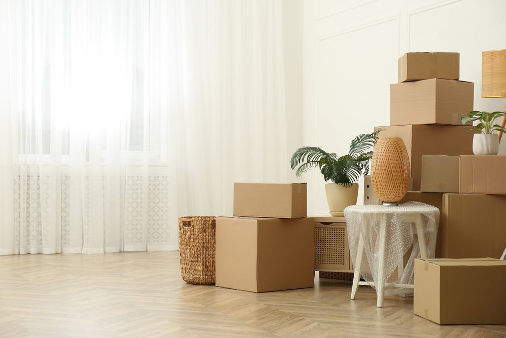 Living Room with Stacked Cardboard Boxes — Johns Removals Newcastle In Rankin Park, NSW