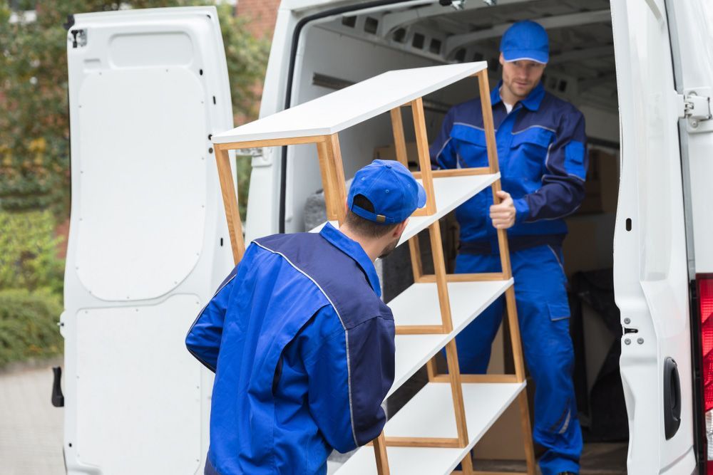 Two Men Are Loading Shelves Into a Van — Johns Removals Newcastle In Rankin Park, NSW