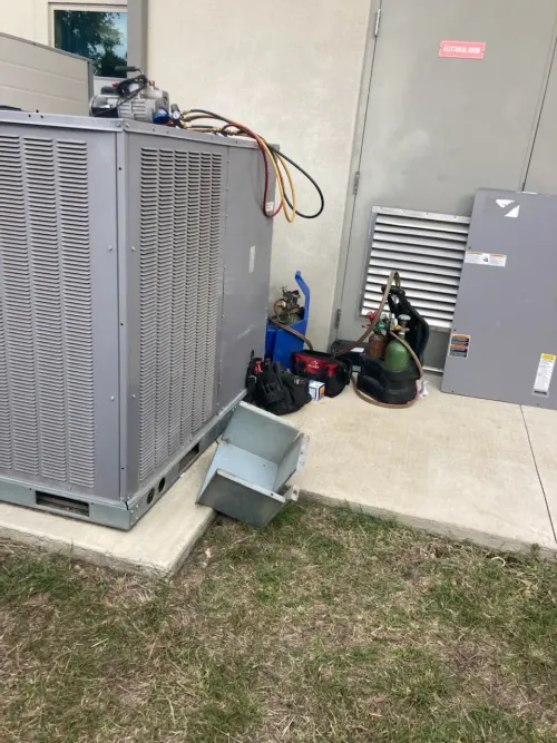 A large air conditioner is sitting on the side of a building.