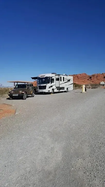 Mobile Detailing-RV and Jeep parked on gravel in a desert landscape with blue sky.