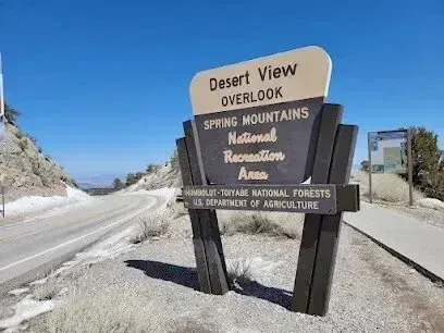 Mobile Detailing-Sign for Desert View Overlook, Spring Mountains National Recreation Area, next to a road, with a clear blue sky.