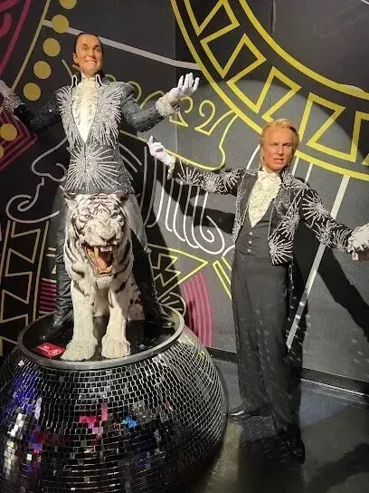 Mobile Detailing-Wax figures of Siegfried and Roy, in matching silver-detailed suits, one atop a tiger on a disco ball.