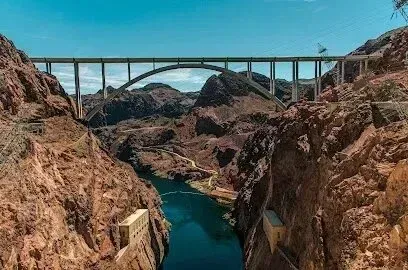 Mobile Detailing-Mike O’Callaghan–Pat Tillman Memorial Bridge spans Black Canyon. Brown canyon walls frame the deep blue Colorado River below a clear sky.