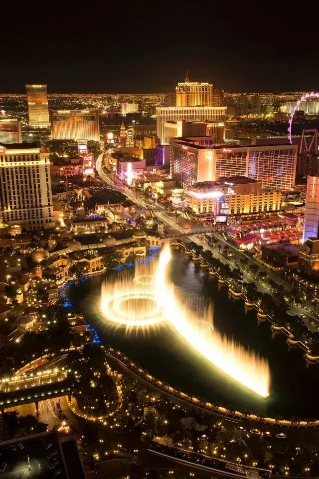 Mobile Detailing - An aerial view of las vegas at night with a fountain in the middle of the city
