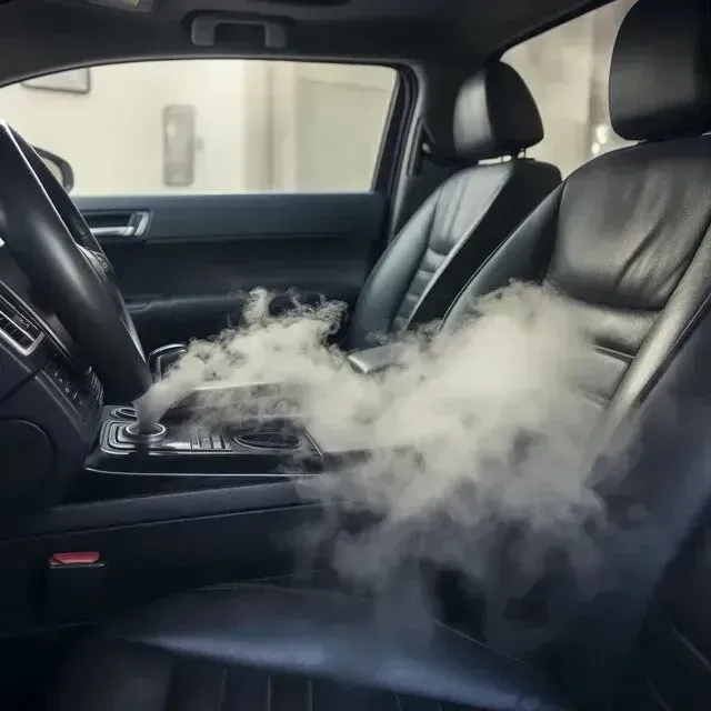 Mobile Detailing - The inside of a car with smoke coming out of the seats