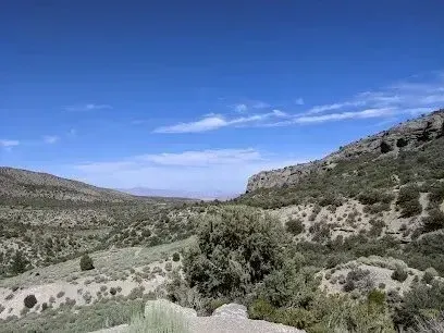 Mobile Detailing-Valley landscape with blue sky, green shrubs and hills under the sun.
