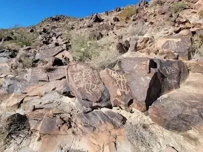 Mobile Detailing - a group of rocks with petroglyphs on them are sitting on top of a hill .