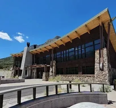 Mobile Detailing-Modern building with stone and wood accents, set against a mountain and blue sky.