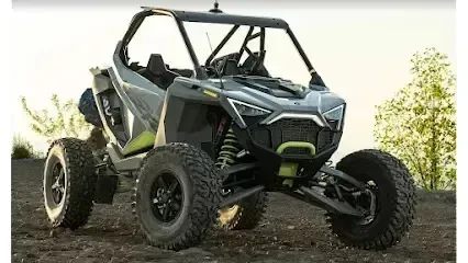 Mobile Detailing-A gray and black Polaris RZR side-by-side off-road vehicle on a dirt road.