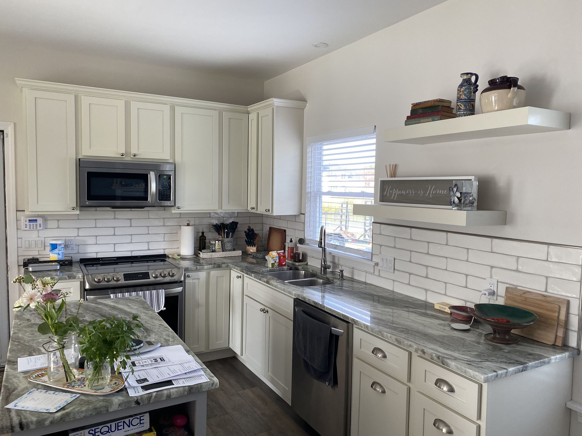 A kitchen with white cabinets and stainless steel appliances.