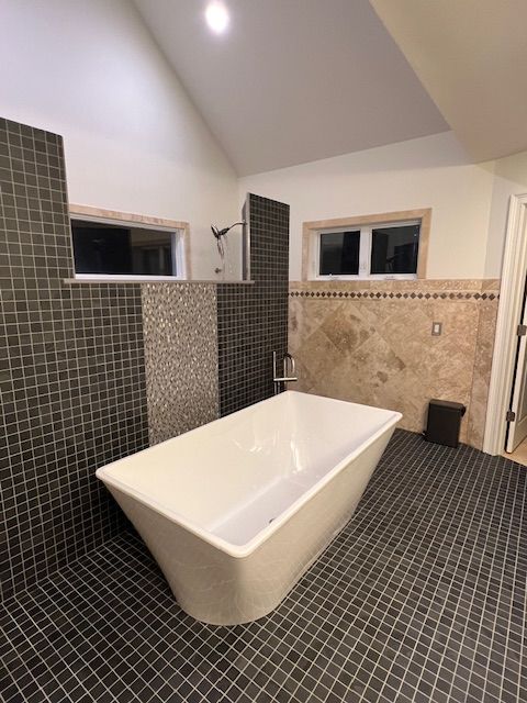 A bathroom with a bathtub and a shower.