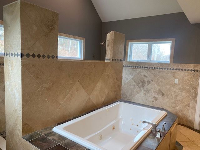 There is a large bathtub in the middle of the bathroom.