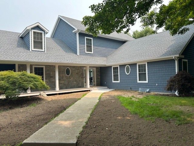 A large blue house with a walkway leading to it