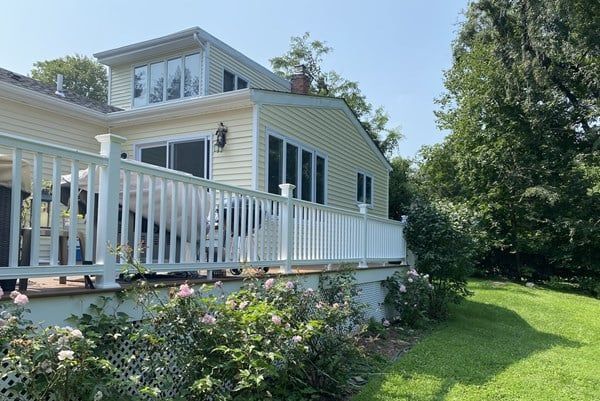 A house with a white deck and a white railing