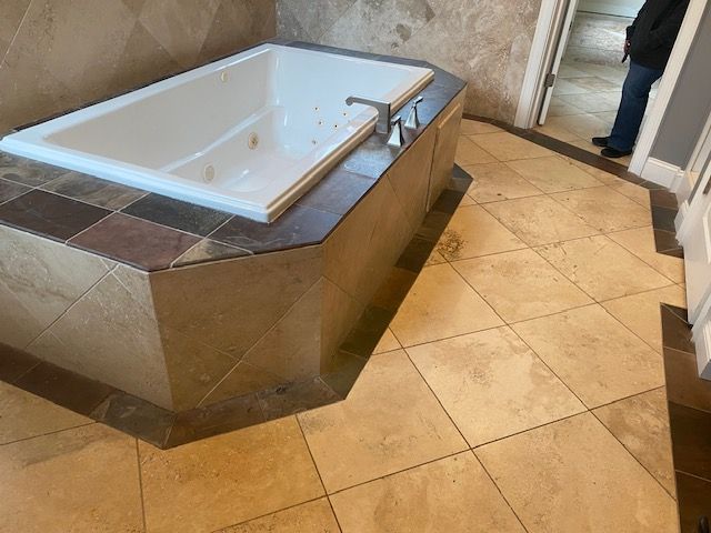 A bathroom with a jacuzzi tub and a tiled floor