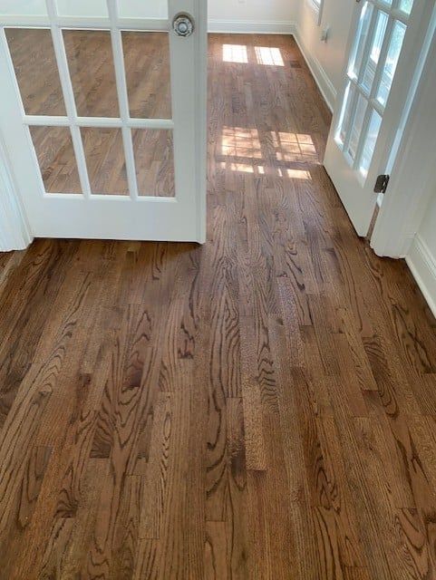 A room with hardwood floors and a white door.