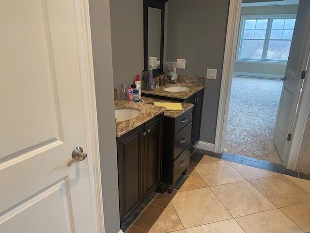 A bathroom with two sinks and a mirror.