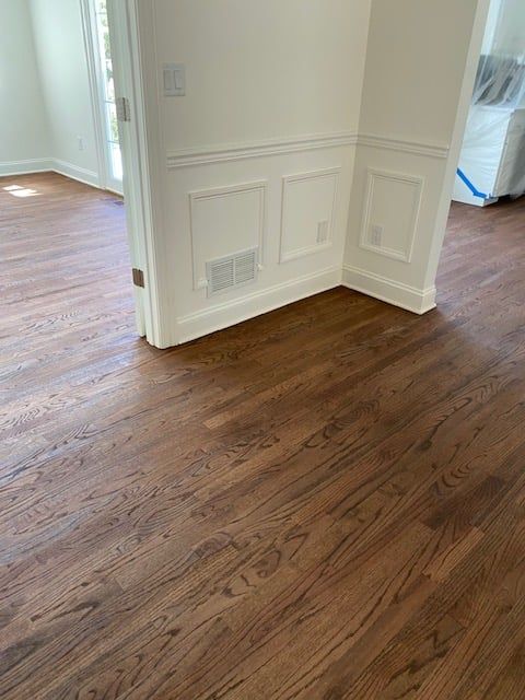 A room with hardwood floors and white walls.