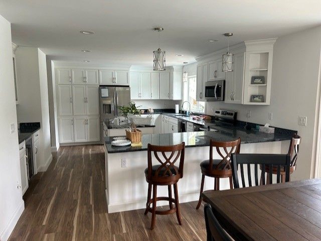 A kitchen with a table and chairs in it