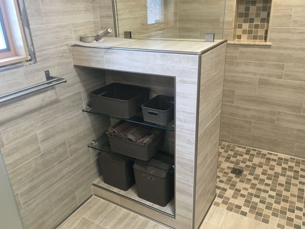 A bathroom with a sink and a shelf with baskets on it.