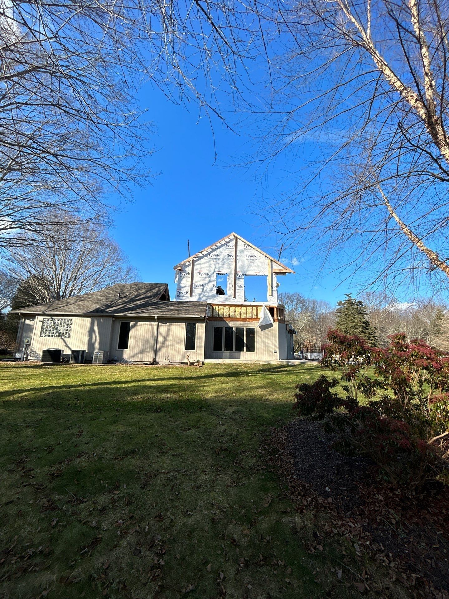 A house under construction with a blue sky in the background.