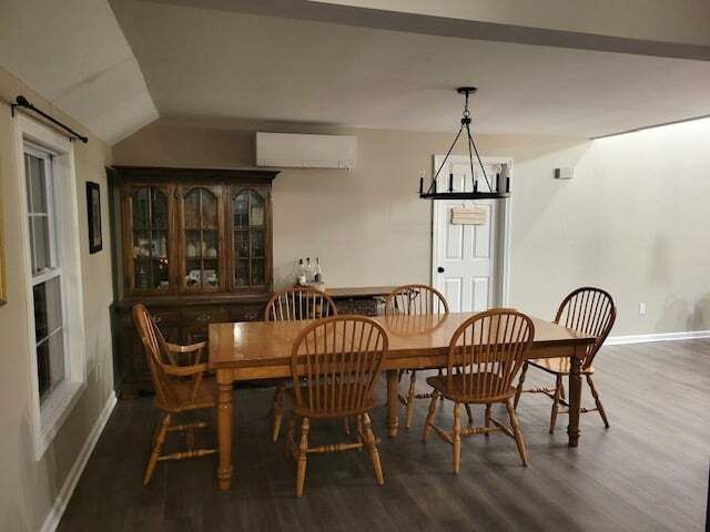 A dining room with a table and chairs and a chandelier