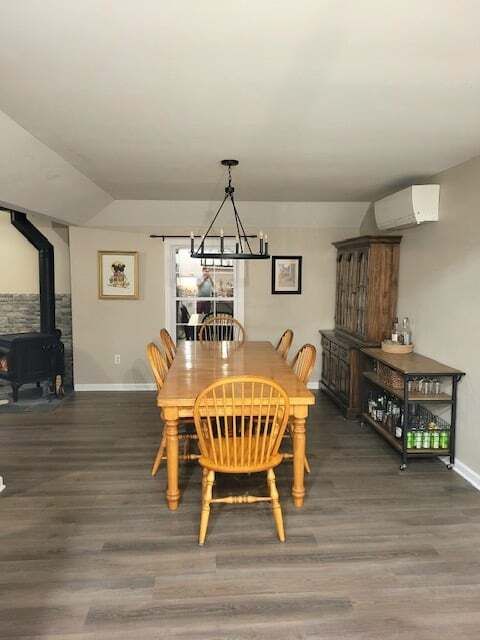 A dining room with a wooden table and chairs