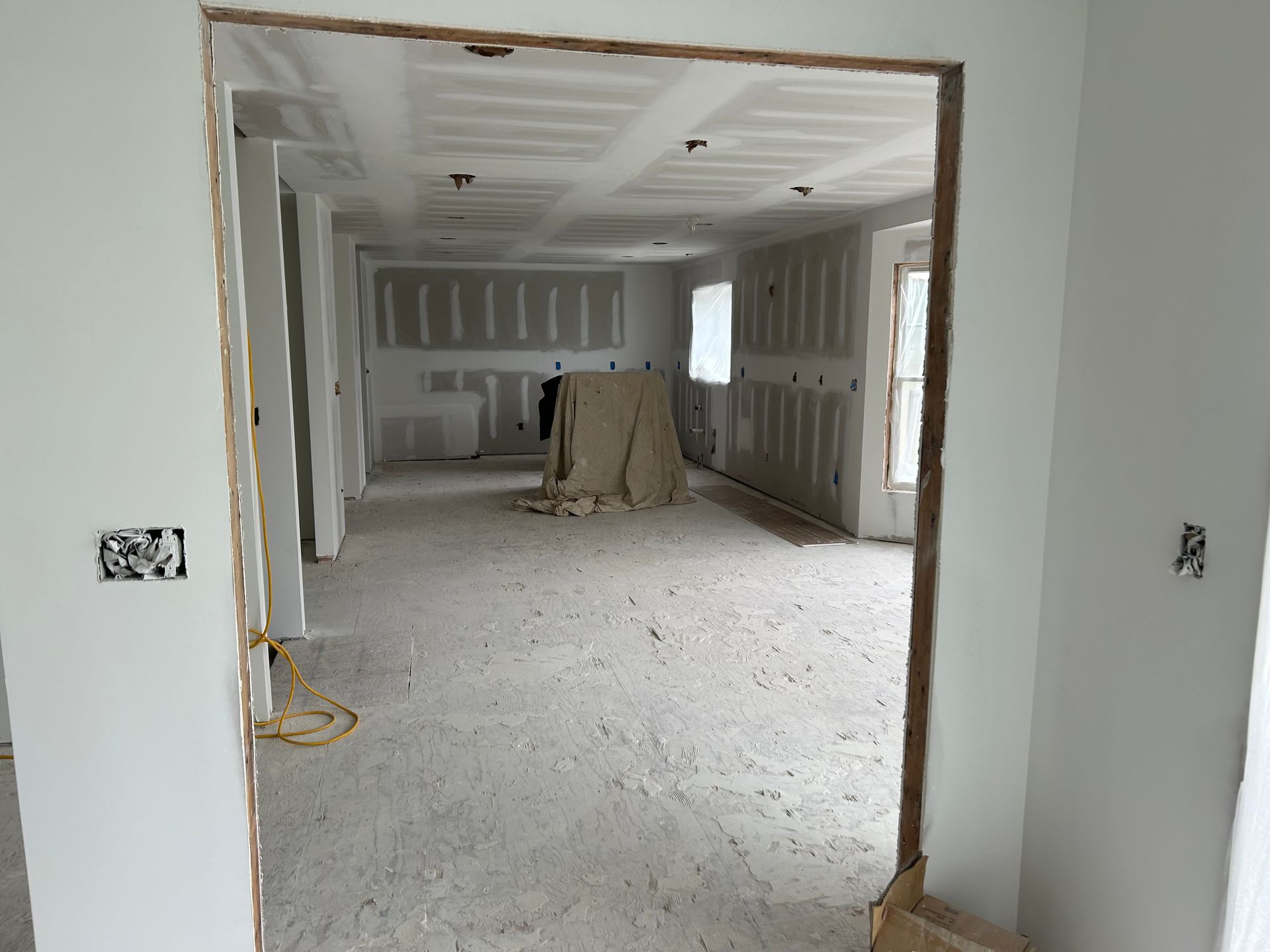 A room that is being remodeled with drywall on the walls