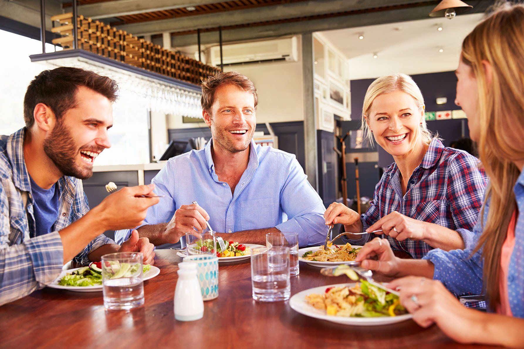 A group of people are sitting at a table eating food.